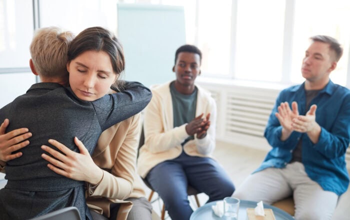 women hugging representing more recovery fewer overdoses